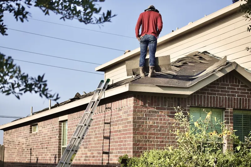 Professional roofer working on a residential roof in East Trenton